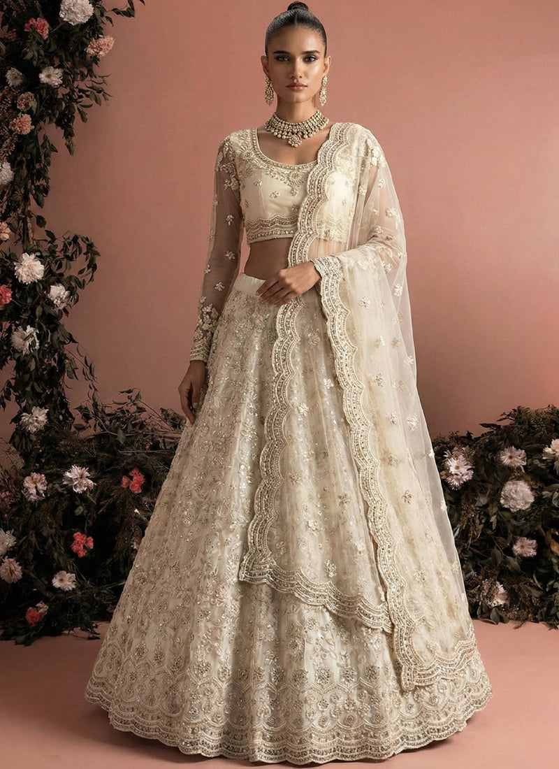 Off White Net Heavy Embroidered Wedding Lehenga