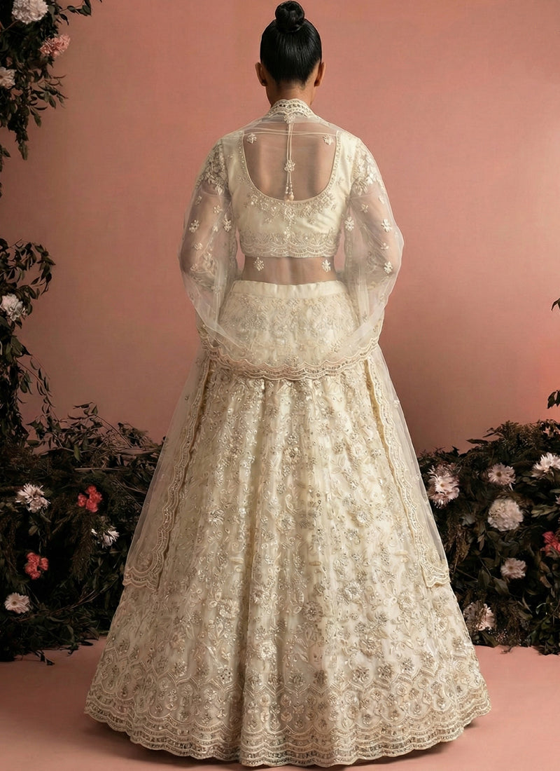 Off White Net Heavy Embroidered Wedding Lehenga