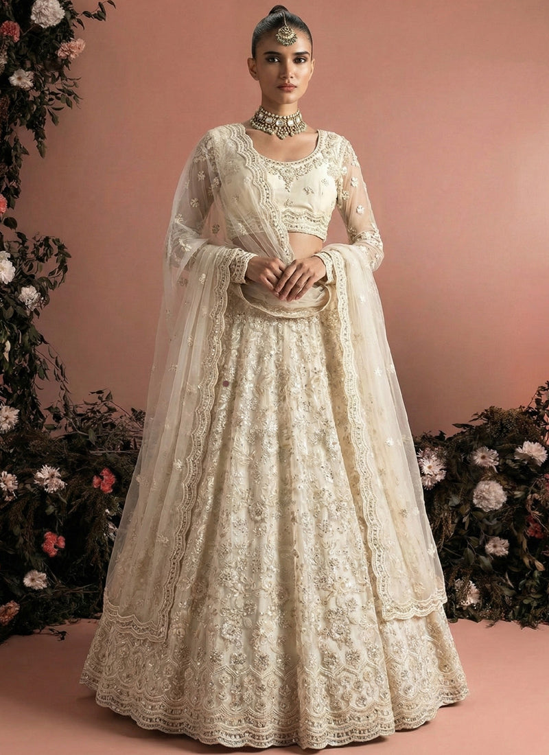 Off White Net Heavy Embroidered Wedding Lehenga